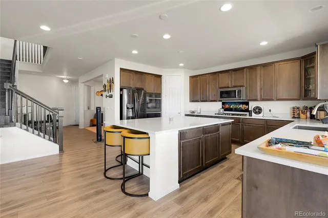 a kitchen with sink cabinets and wooden floor