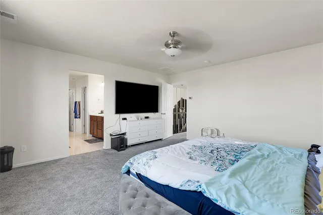 a living room with a white furniture and flat screen tv