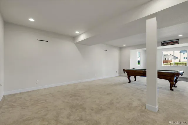 an empty room with windows and furniture