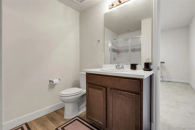 a bathroom with a sink toilet and a mirror