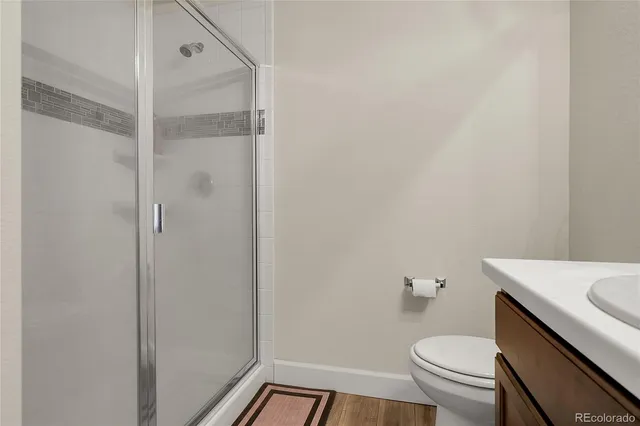 a bathroom with a sink a toilet and a shower