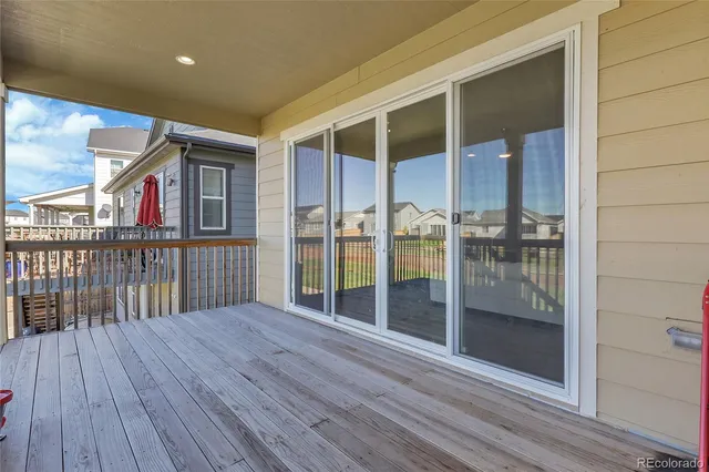 a view of a balcony with floor to ceiling window wooden floor and wooden floor