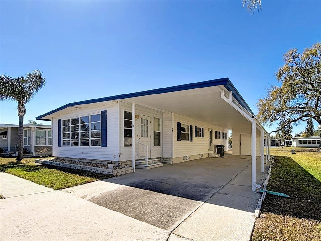 1100 South Belcher Road, Unit 561 Largo, FL 33771 - Photo 1 of 23 a front view of a house with a yard