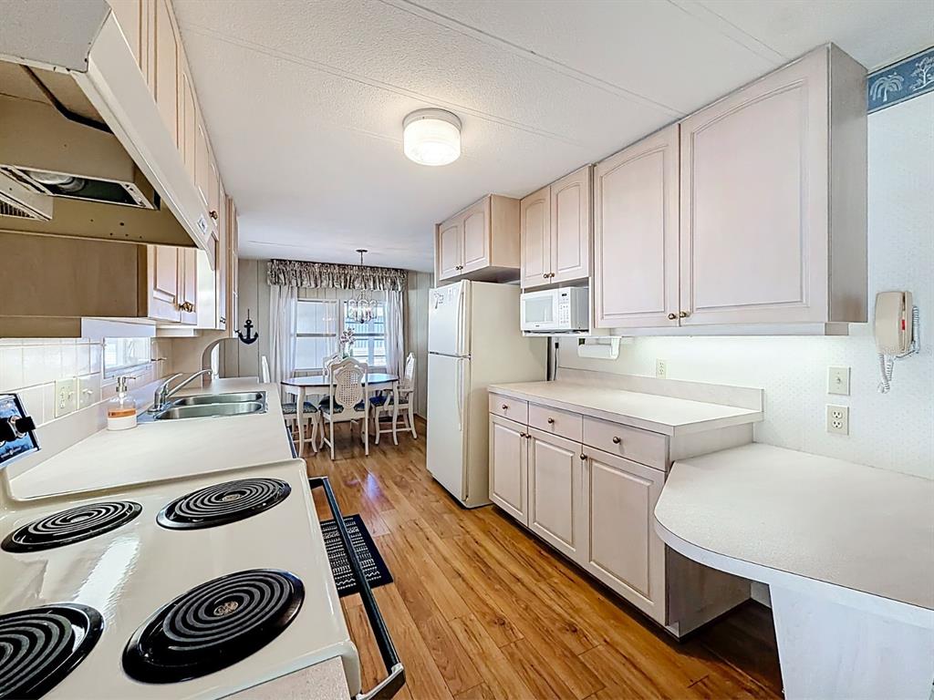 1100 South Belcher Road, Unit 561 Largo, FL 33771 - Photo 11 of 23 a kitchen with sink a stove and cabinets