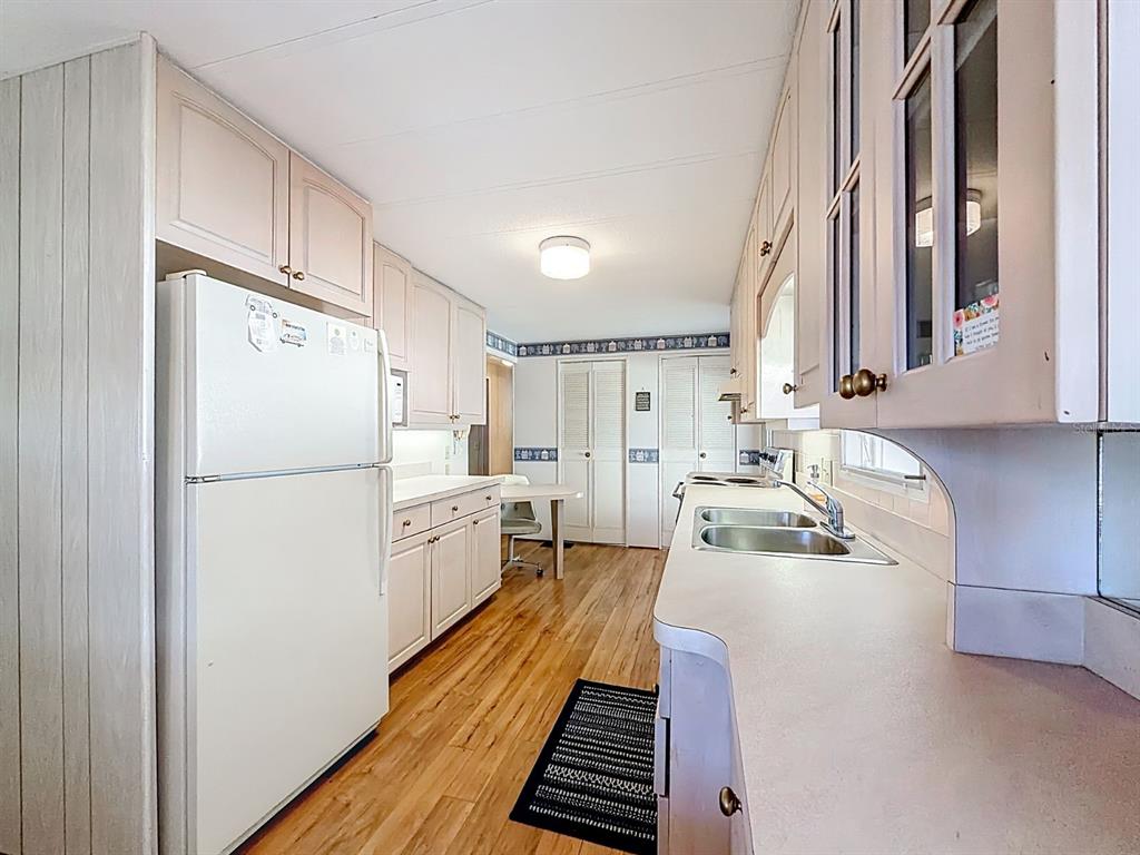 1100 South Belcher Road, Unit 561 Largo, FL 33771 - Photo 12 of 23 a kitchen with a refrigerator a sink and dishwasher