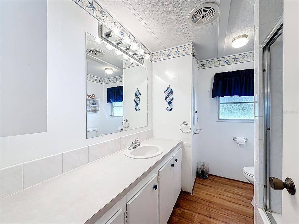 1100 South Belcher Road, Unit 561 Largo, FL 33771 - Photo 15 of 23 a bathroom with a sink a toilet and shower