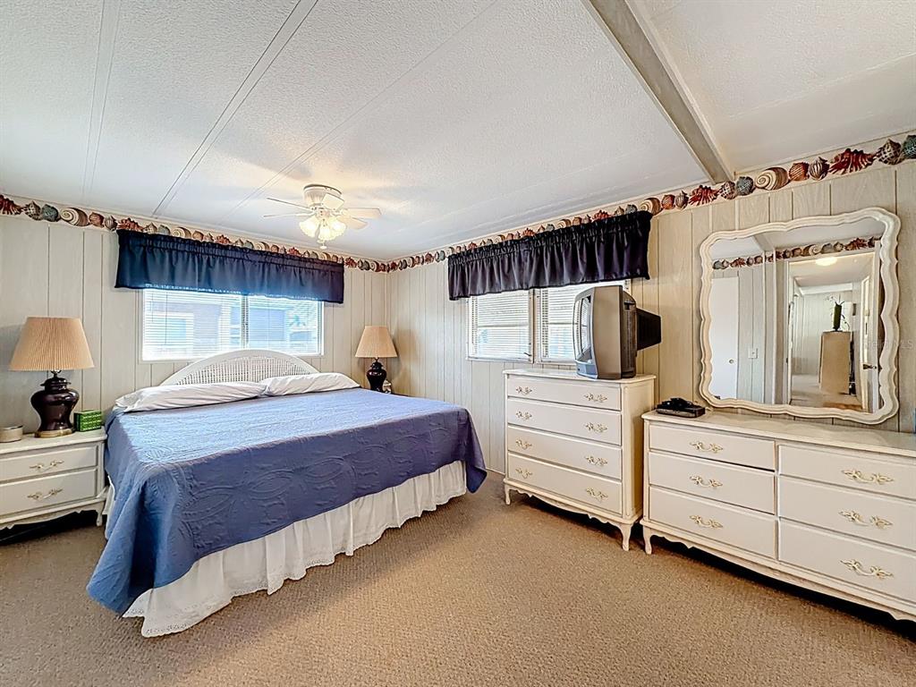 1100 South Belcher Road, Unit 561 Largo, FL 33771 - Photo 17 of 23 a bedroom with a bed and a dresser