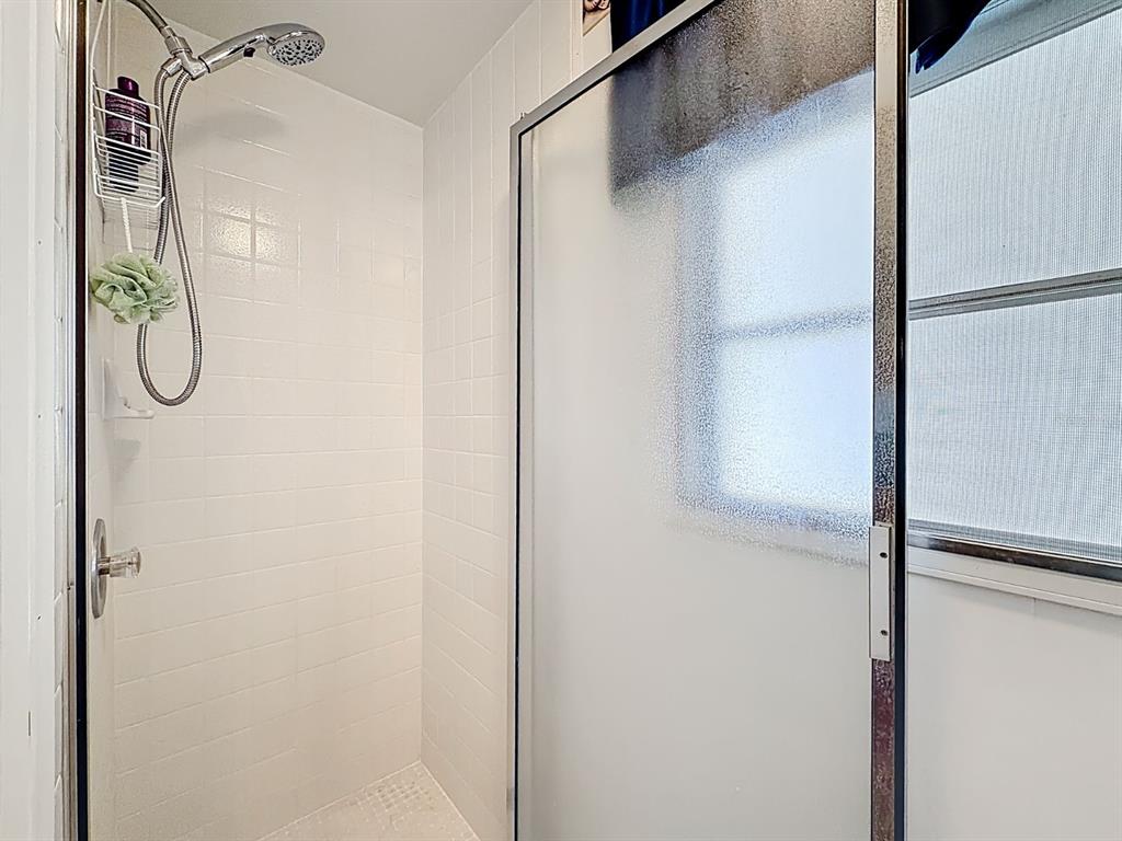 1100 South Belcher Road, Unit 561 Largo, FL 33771 - Photo 21 of 23 a bathroom with a glass shower door