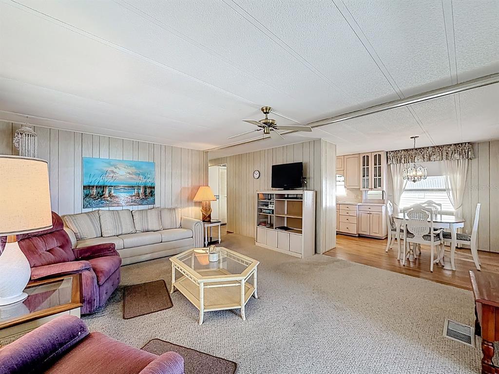 1100 South Belcher Road, Unit 561 Largo, FL 33771 - Photo 3 of 23 a living room with furniture and a flat screen tv