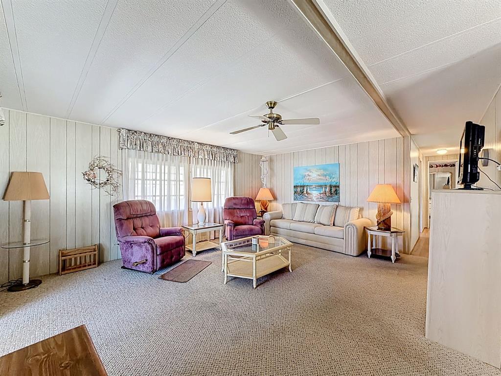 1100 South Belcher Road, Unit 561 Largo, FL 33771 - Photo 4 of 23 a living room with furniture and a chandelier