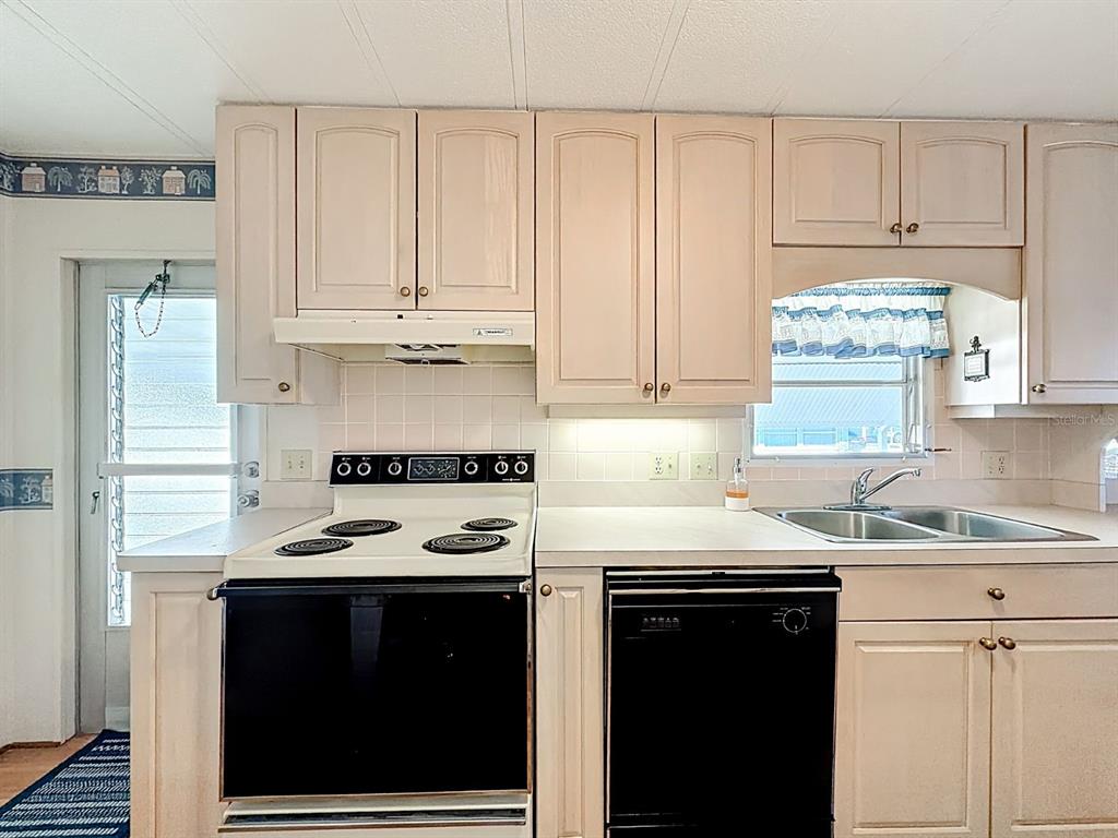 1100 South Belcher Road, Unit 561 Largo, FL 33771 - Photo 8 of 23 a kitchen with a sink stove and cabinets