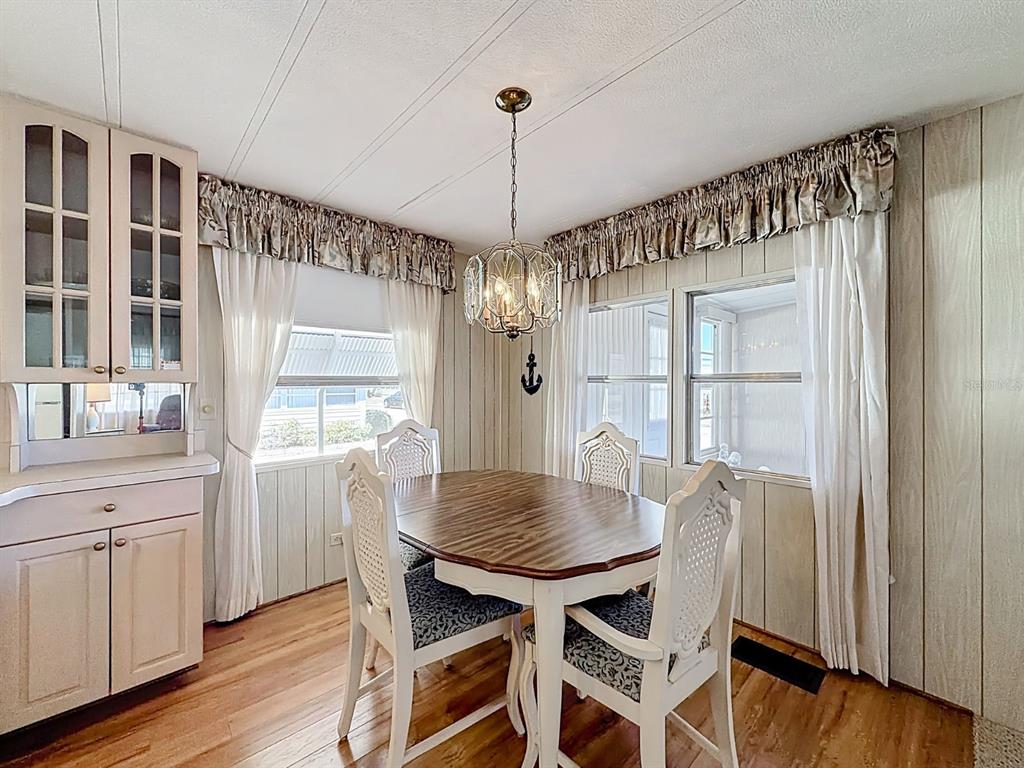 1100 South Belcher Road, Unit 561 Largo, FL 33771 - Photo 9 of 23 a view of a dining room with furniture window and wooden floor