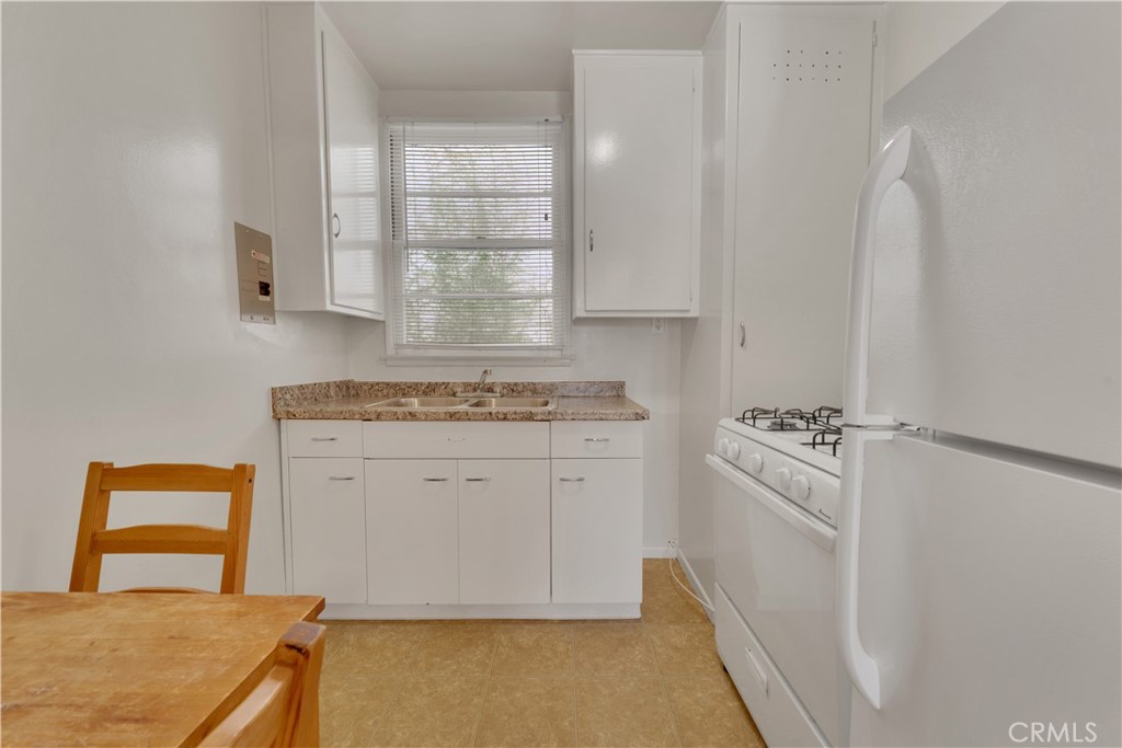 30 North 1st Street, Unit 8 Alhambra, CA 91801 - Photo 3 of 6 a kitchen with white cabinets and white appliances