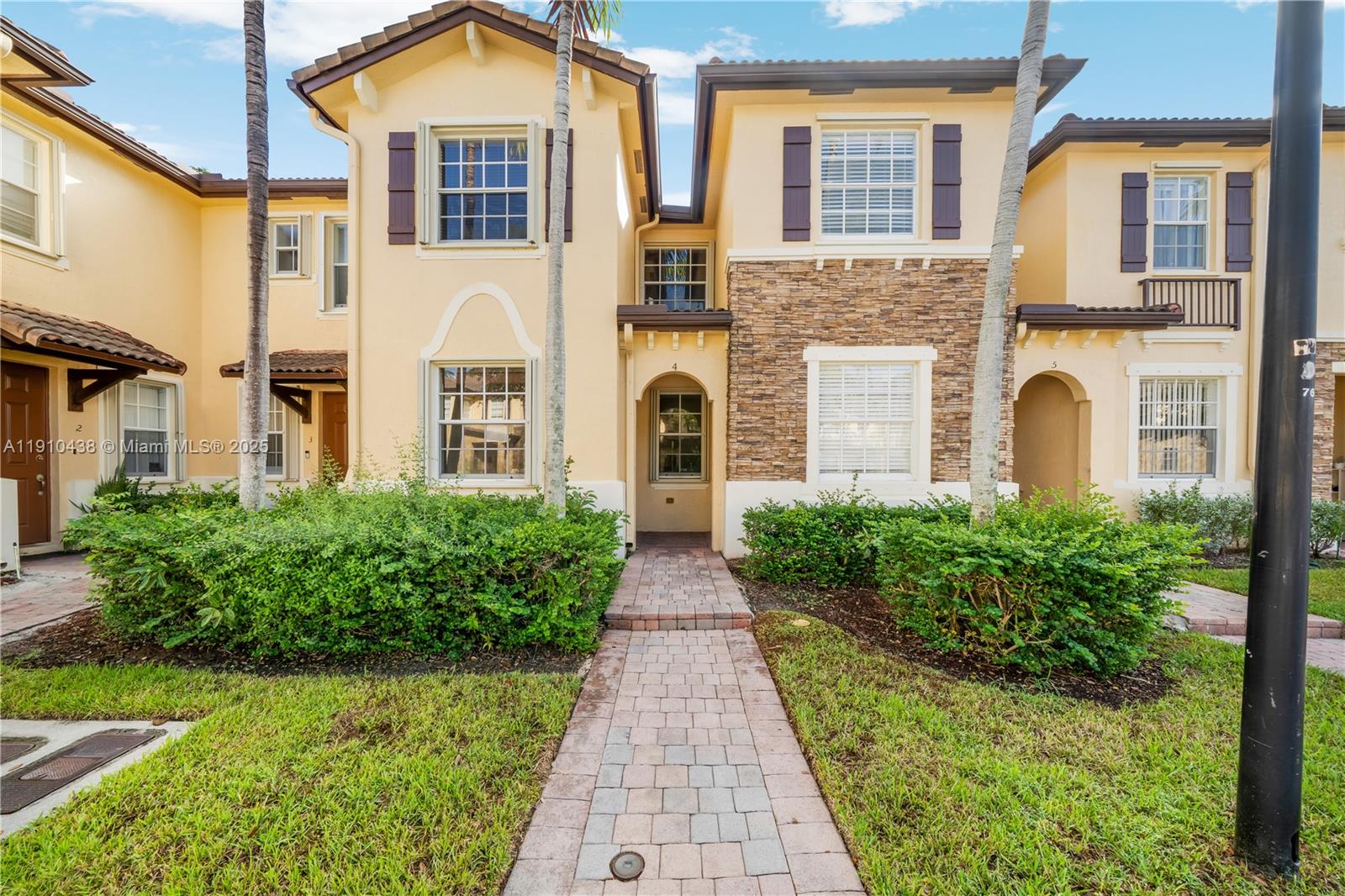 9239 Southwest 227th Street, Unit 4 Cutler Bay, FL 33190 - Photo 1 of 29 a front view of a building with garden
