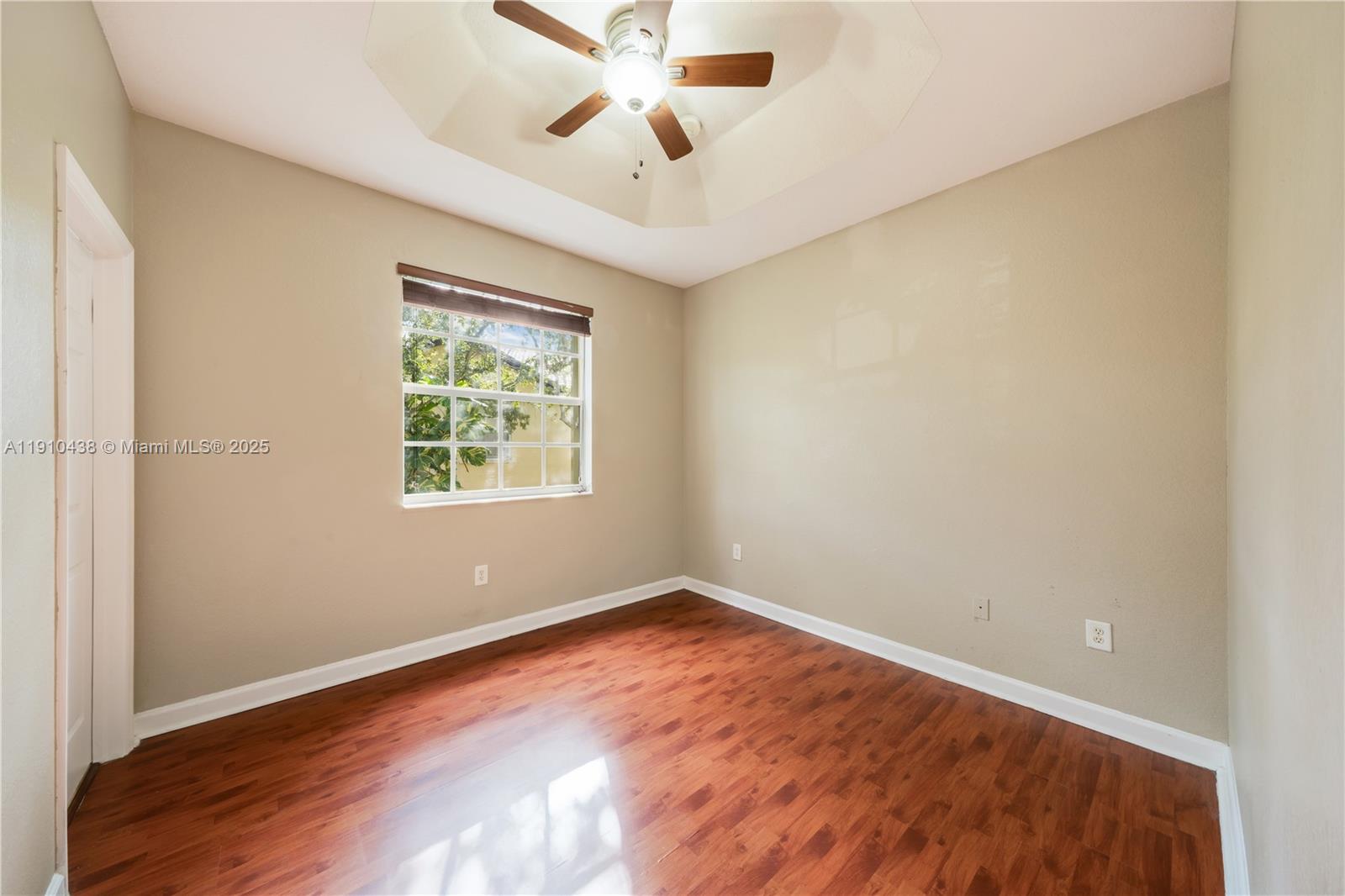 9239 Southwest 227th Street, Unit 4 Cutler Bay, FL 33190 - Photo 19 of 29 an empty room with windows and fan