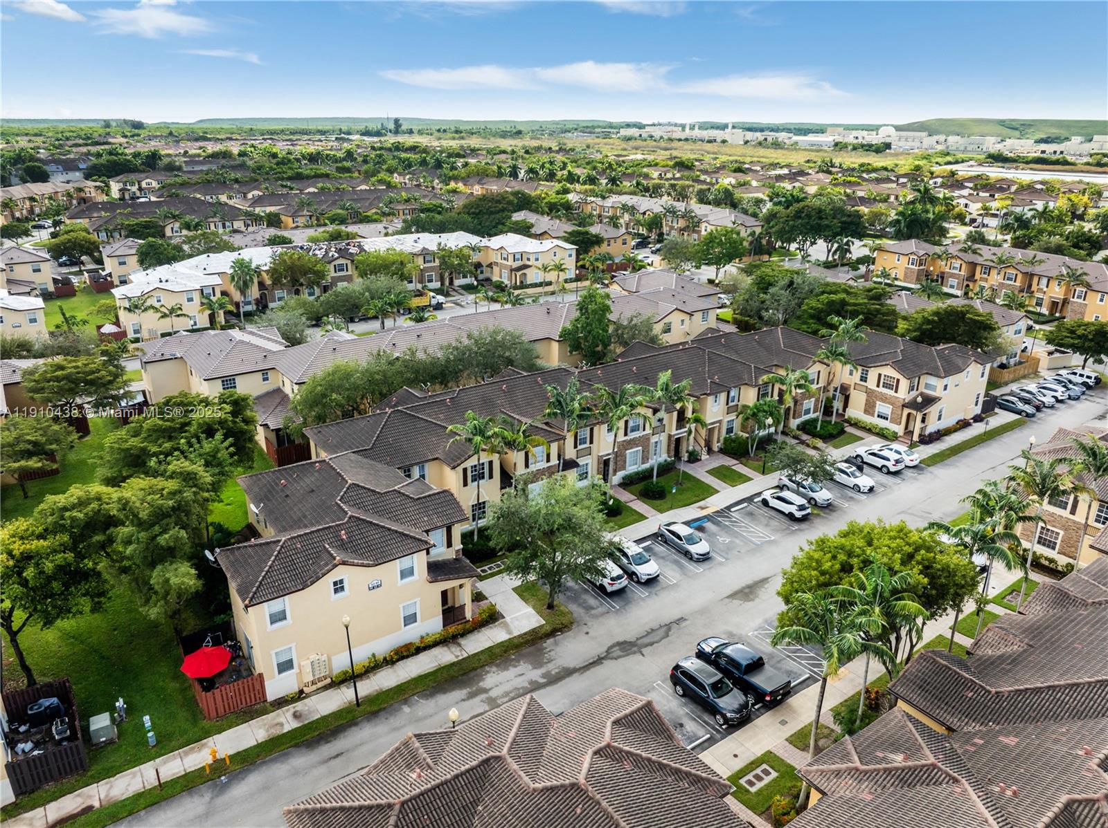 9239 Southwest 227th Street, Unit 4 Cutler Bay, FL 33190 - Photo 25 of 29 an aerial view of a city with lots of residential buildings