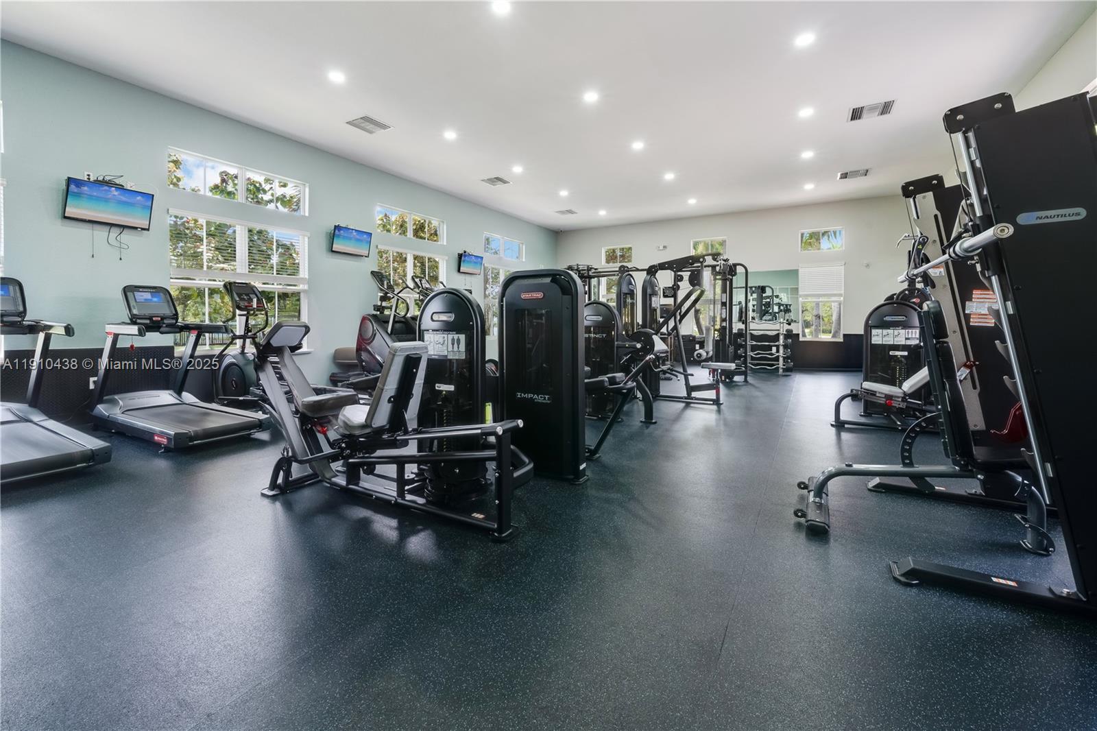 9239 Southwest 227th Street, Unit 4 Cutler Bay, FL 33190 - Photo 6 of 29 a view of a room with gym equipment