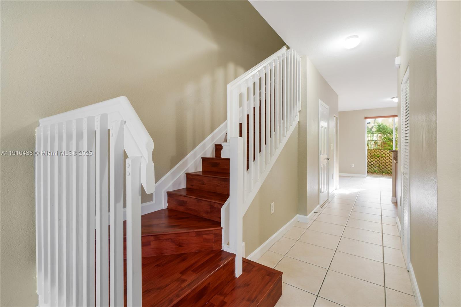 9239 Southwest 227th Street, Unit 4 Cutler Bay, FL 33190 - Photo 9 of 29 a view of entryway and hall with wooden floor