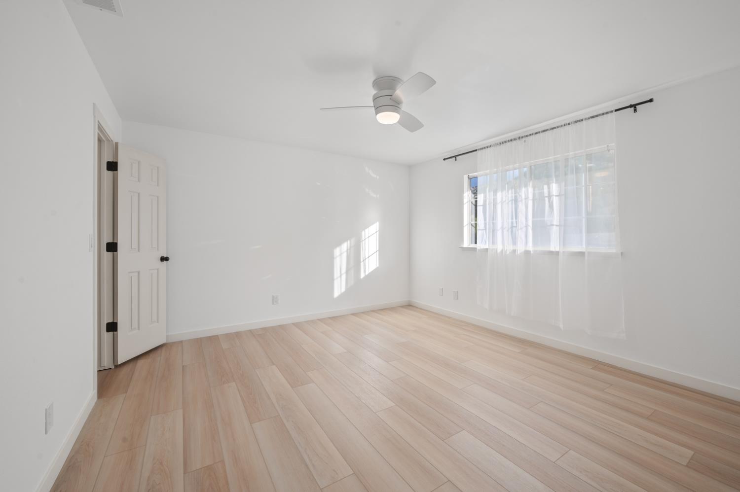 38570 Rustic Lane Squaw Valley, CA 93675 - Photo 18 of 43 an empty room with wooden floor and windows
