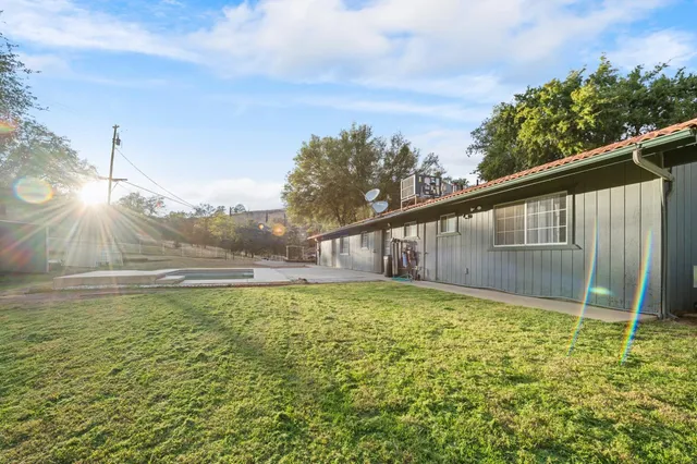 a backyard of a house with lots of green space and plants