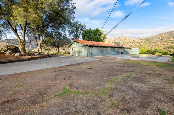 a view of a house with a yard and garage