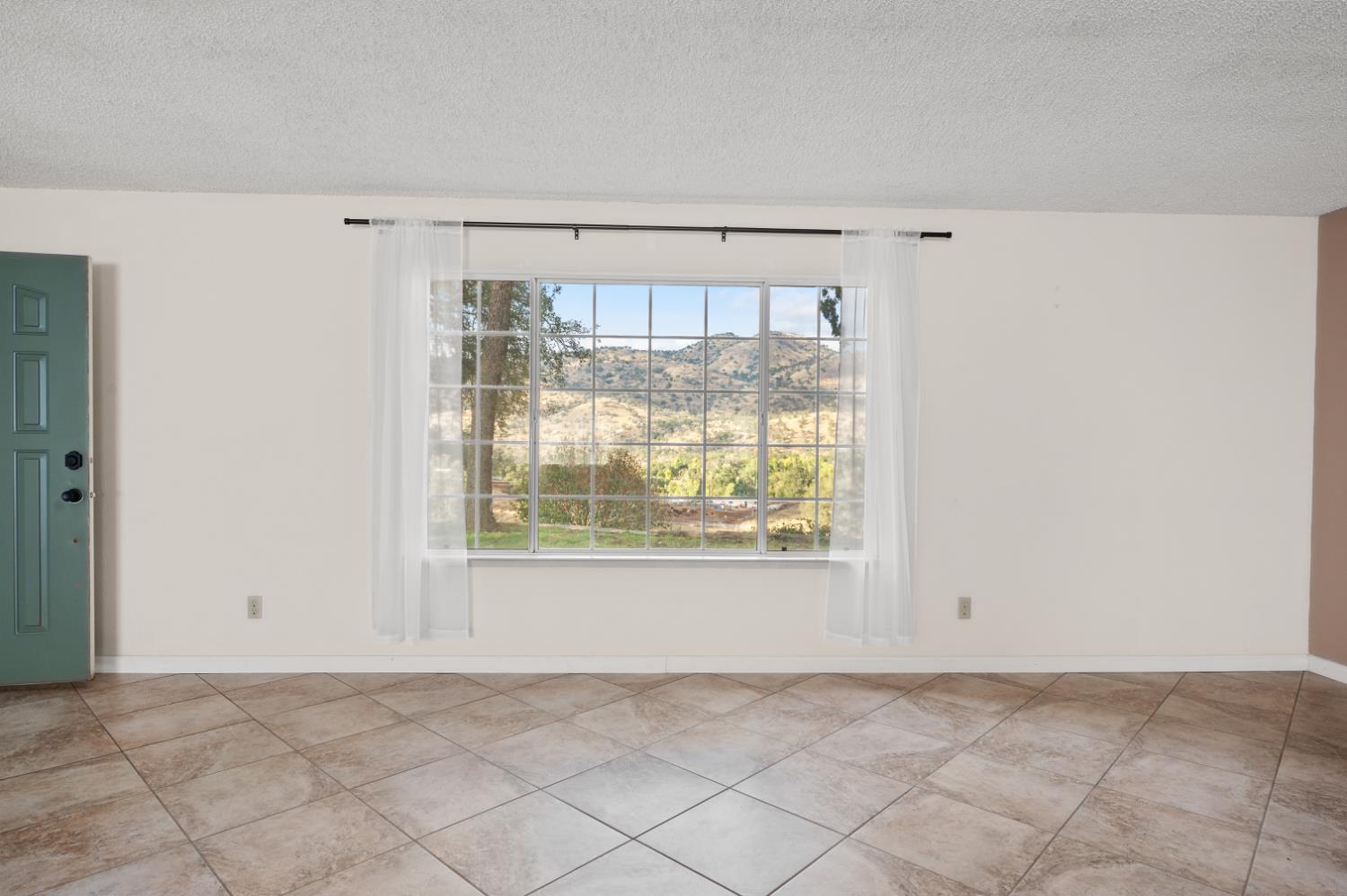 38570 Rustic Lane Squaw Valley, CA 93675 - Photo 6 of 43 a view of an empty room with a window