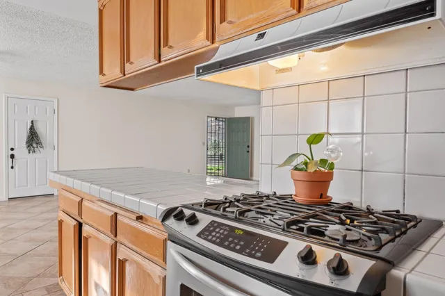 a stove top oven sitting inside of a kitchen