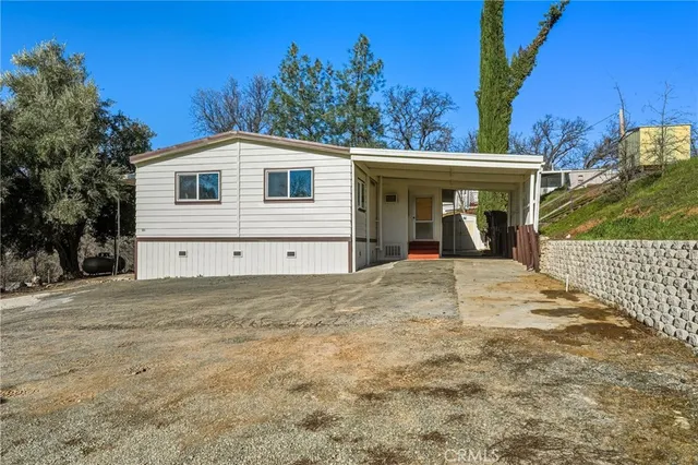 a view of a white house with a yard and garage