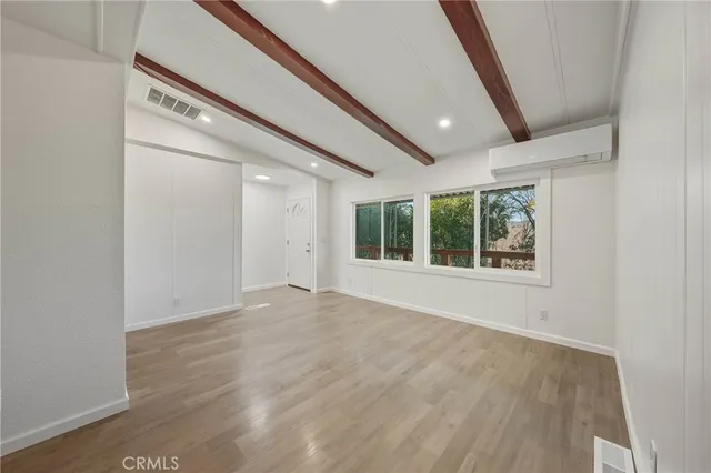a view of an empty room and wooden floor