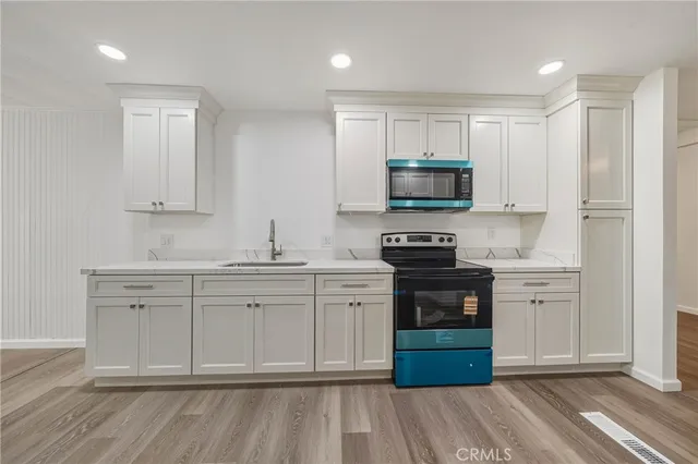 a view of cabinets a wooden floor and window in a room