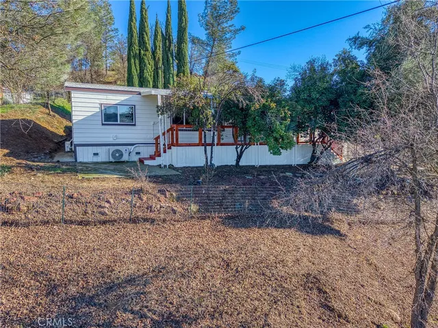 a view of a backyard with large trees
