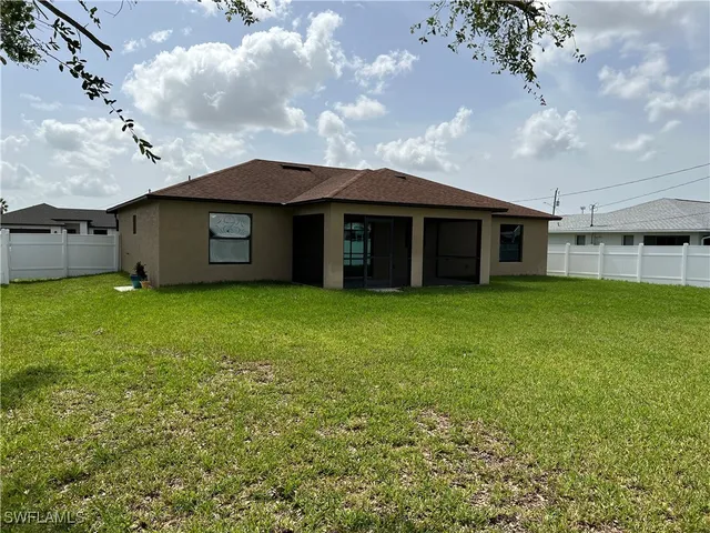 a view of a house with a garden and yard