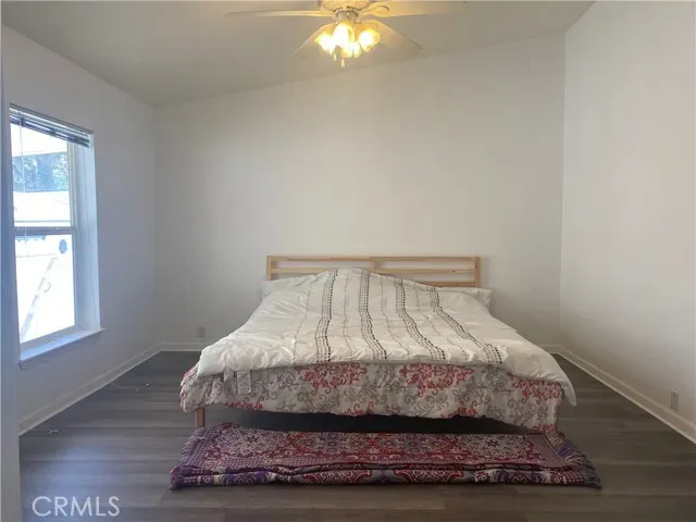 a bed sitting in a bedroom next to a window