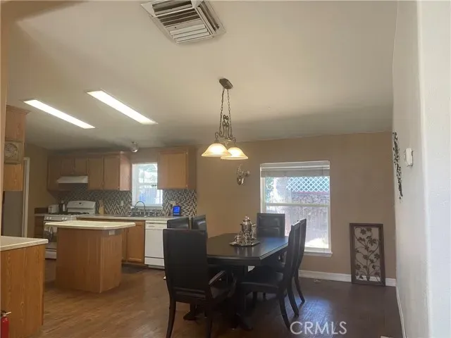 a view of a dining room with furniture and window
