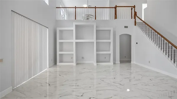 a kitchen with a refrigerator a stove a sink and a chandelier