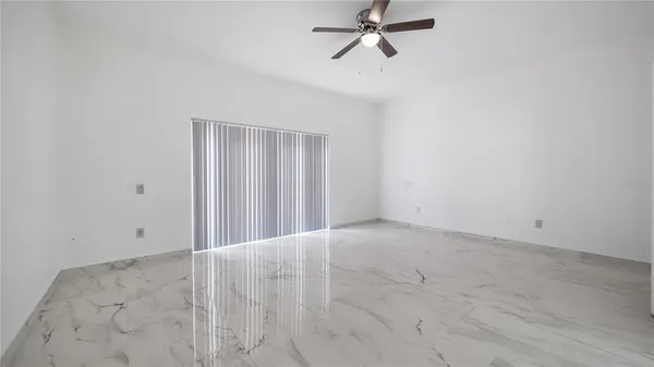 a view of empty room with closet and fan