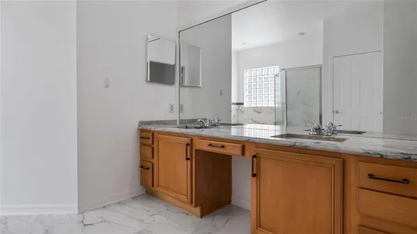 a spacious bathroom with stainless steel appliances a sink and a bathtub