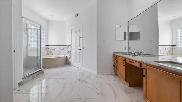 a white bath tub sitting next to a white sink
