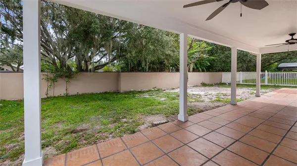 a front view of a house with a yard and potted plants