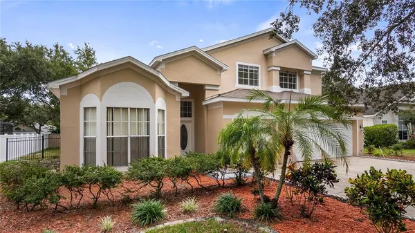 a kitchen with stainless steel appliances kitchen island granite countertop a refrigerator stove top oven and sink