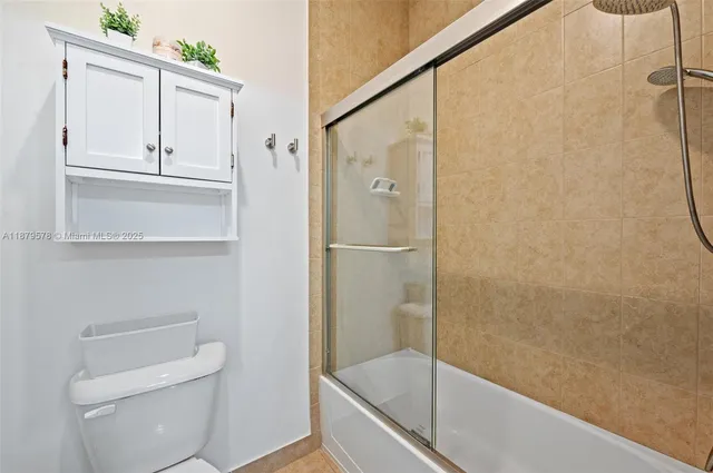 a bathroom with a shower and toilet