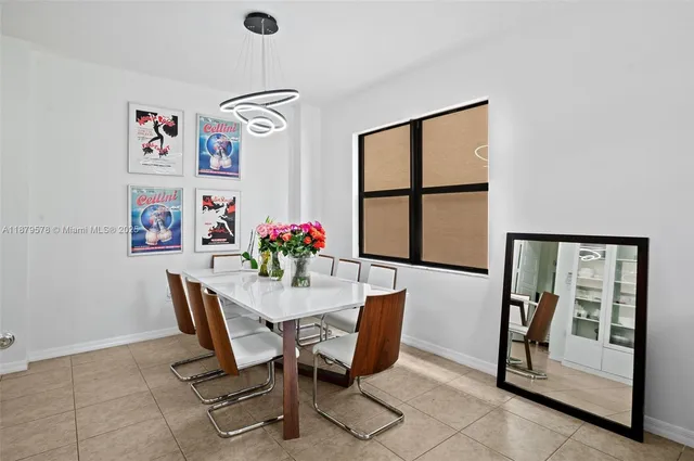 a view of a dining room with furniture and a window
