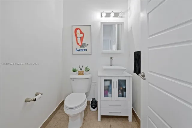 a white toilet sitting next to a bathroom sink