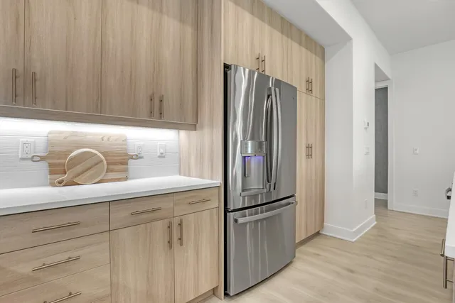 a kitchen with a refrigerator and cabinets
