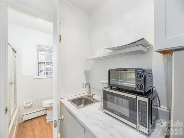 a bathroom with a sink toilet and mirror