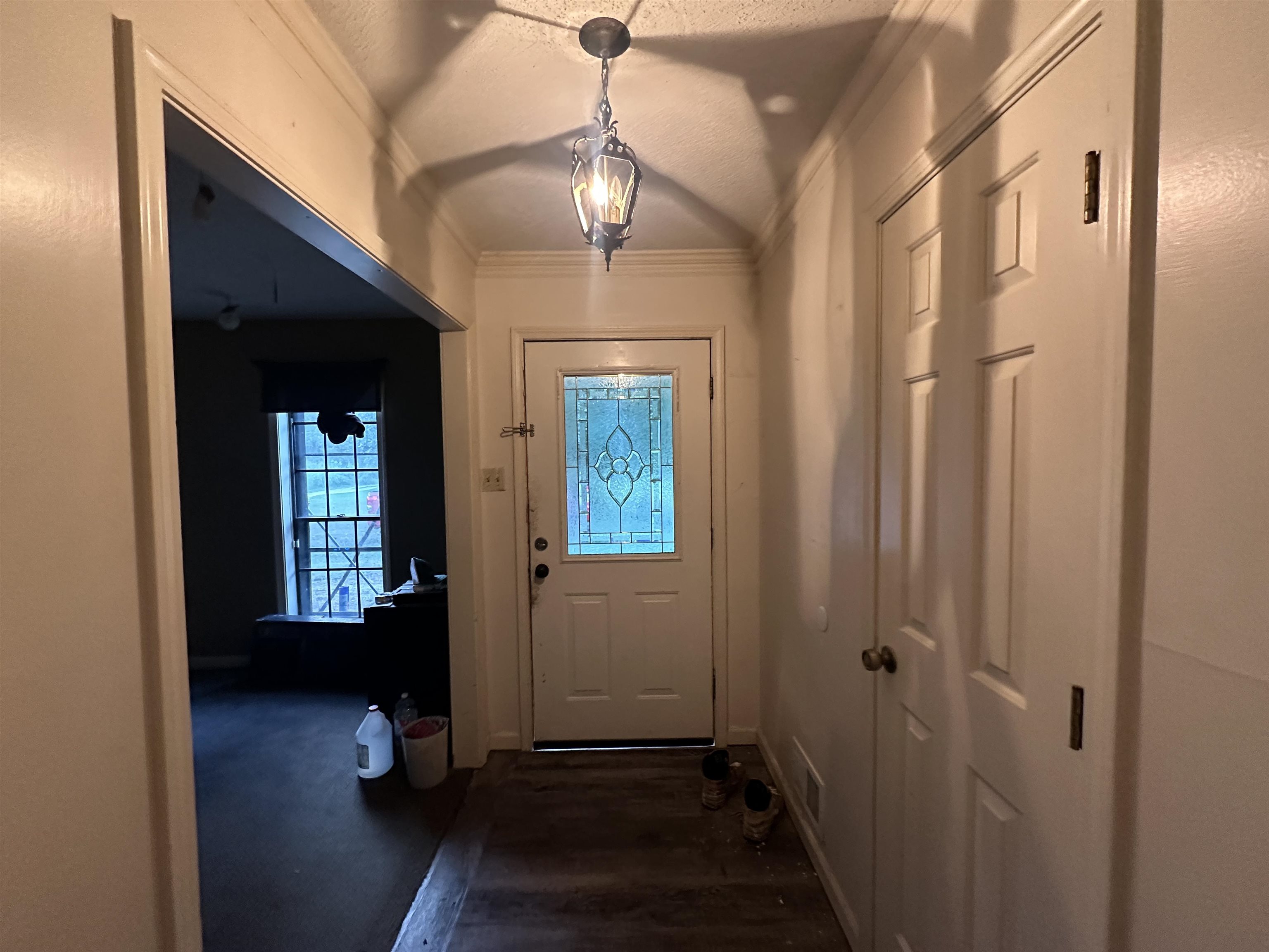 1402 Bridgewater Road Cordova, TN 38018 - Photo 3 of 30 Entryway featuring a textured ceiling, crown molding, and dark hardwood / wood-style flooring