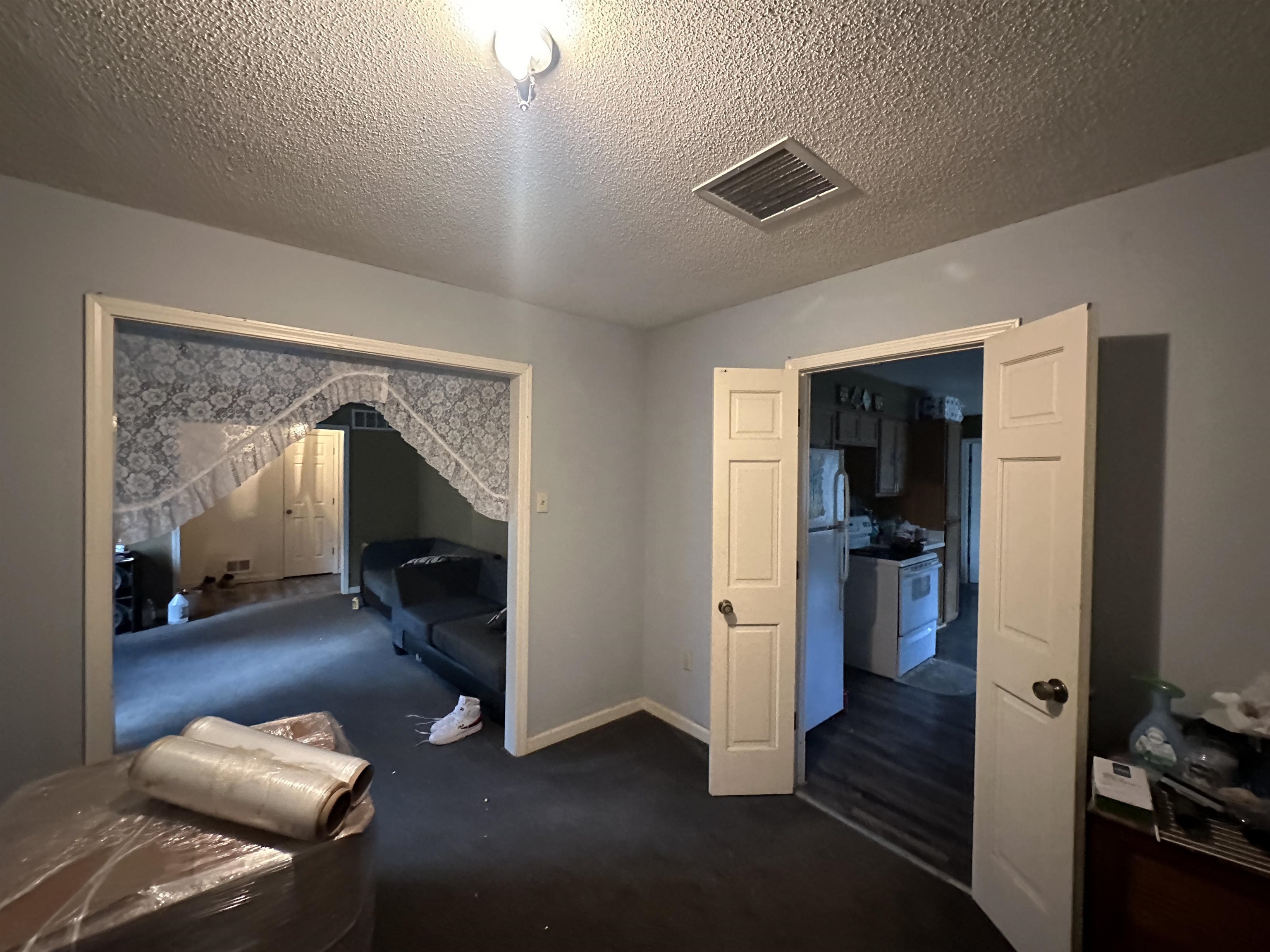 1402 Bridgewater Road Cordova, TN 38018 - Photo 4 of 30 Carpeted bedroom with white fridge and a textured ceiling