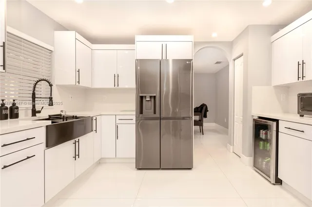 a kitchen with a refrigerator a stove a sink and a cabinets