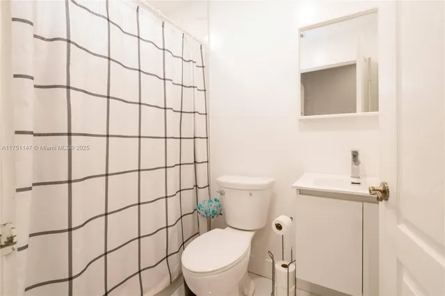 a white toilet sitting next to a bathroom sink
