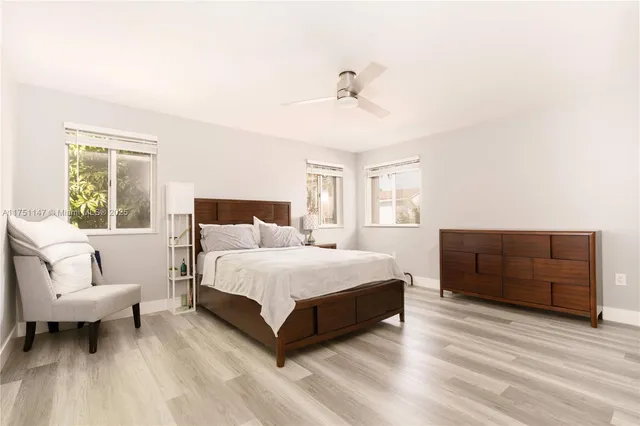 a spacious bedroom with a bed and window